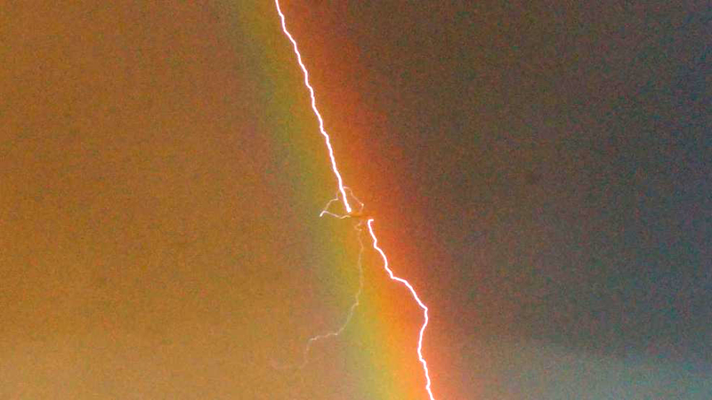 Illustration for article titled Amazing photo shows lightning striking an airliner flying in a rainbow